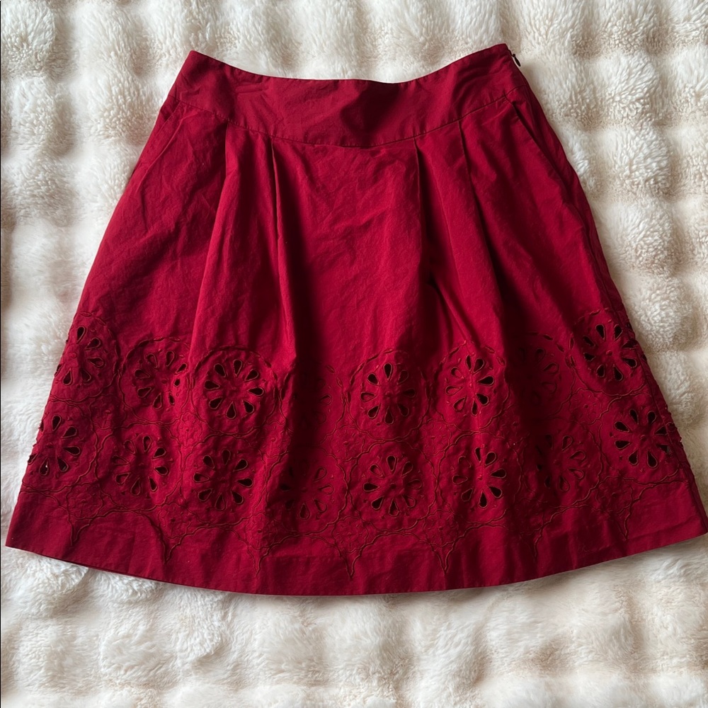 LOFT Red A-Line Skirt with Floral Cutouts. Pockets on both sides.